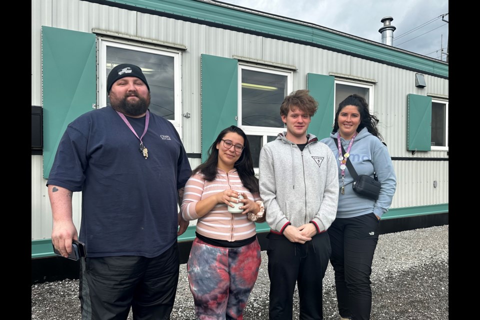 The Elizabeth Fry Society is looking for community donations to help put together holiday gift baskets for youth at Orillia’s supportive rapid rehousing facility. Pictured are transitional support worker Zakary Holdsworth, program participants Val and Sam, and director of housing Kaitlin Odom. 