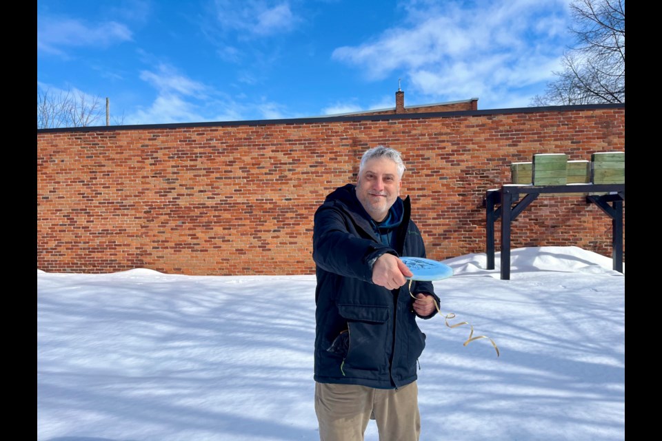 After more than a decade of playing disc golf, Travis Brophy uses a variety of discs. In the winter, he ties colourful ribbons to them for retrieving from the snow.