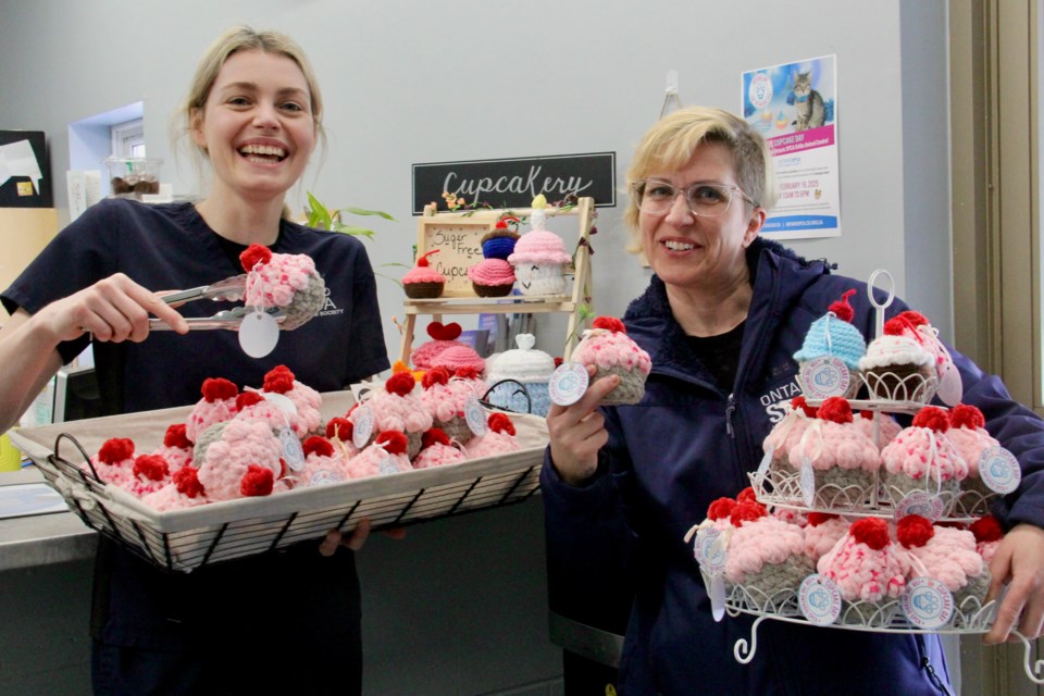 Nicole Ross, left, customer care representative, and Natalie Harris, community outreach co-ordinator for the Ontario SPCA Orillia Animal Centre, show off some of the crocheted cupcakes available through to Feb. 24 for the Cupcake Day fundraiser.