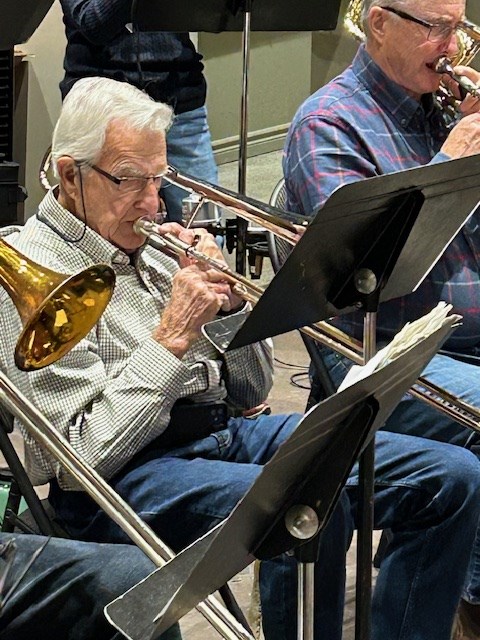 Cliff Whitfield is hanging up his trombone after Saturday night's concert. He has played the big brass instrument in a wide array of bands for 80 years.