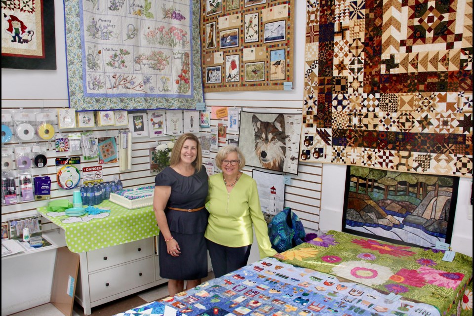 Thimbles and Things owner Paula Trecartin, left, is seen with the store's original owner Sue Polera at the store's recent 25th anniversary event.