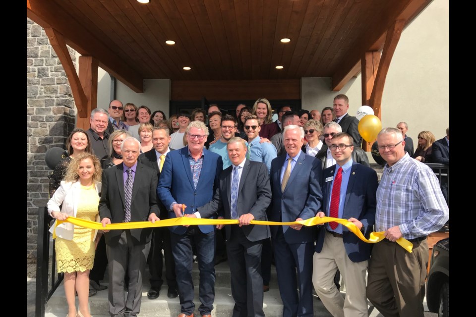 The ribbon was cut to mark the grand opening of the new office of Century 21 B.J. Roth Realty Wednesday afternoon. Above, Mayor Steve Clarke, centre, cuts the ribbon, surrounded by staff and management from the office and the company. Nicole Parkes/OrilliaMatters