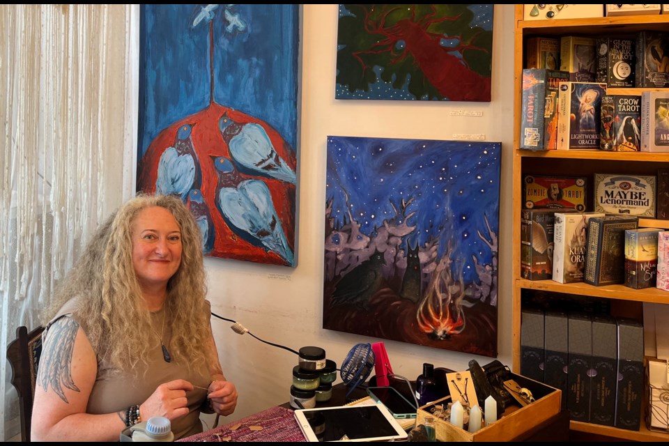 Sylvia Tesori is shown making art behind her desk at Three Crows Speak Studio, in the Peter Street Arts District.