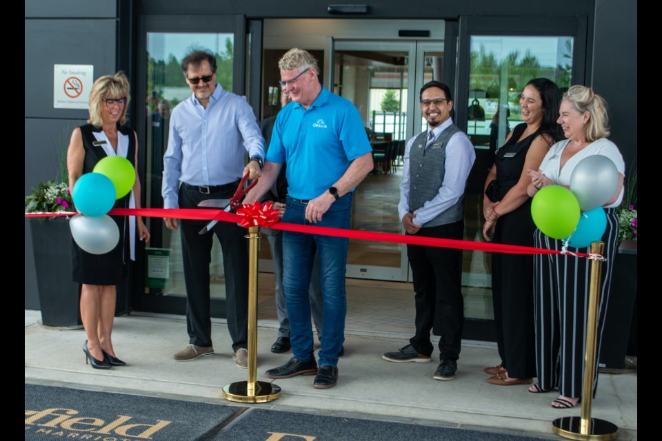 Fairfield by Marriott staff are shown with Mayor Steve Clarke as he cuts the ribbon during the official grand opening of the hotel Wednesday.