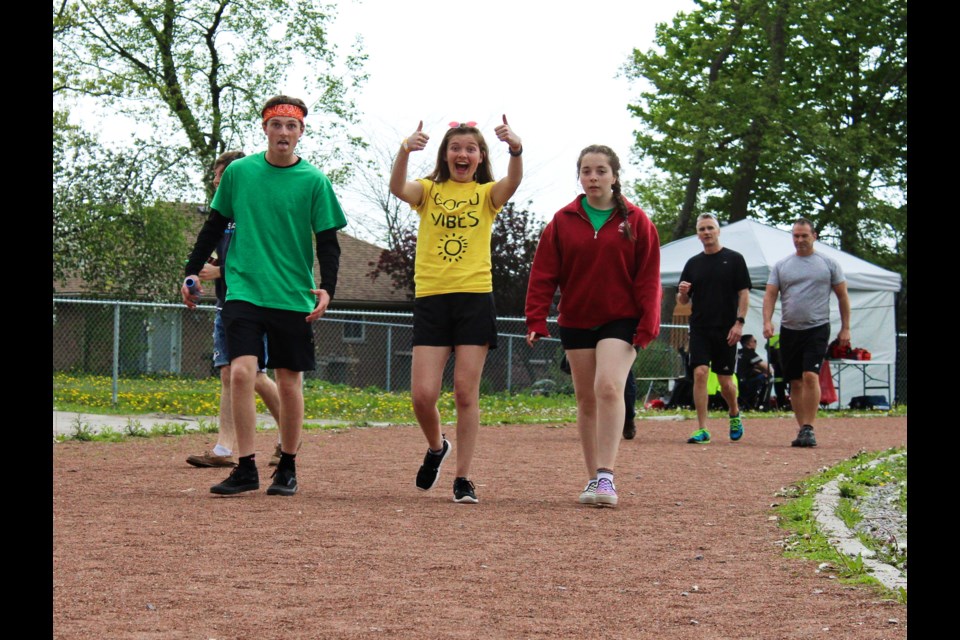 Orillia Secondary School students Hunter Sisson, Jewel Sisson, centre, and Abby Williamson walk the track Friday during the Relay for Life at Orillia Secondary School. Nathan Taylor/OrilliaMatters