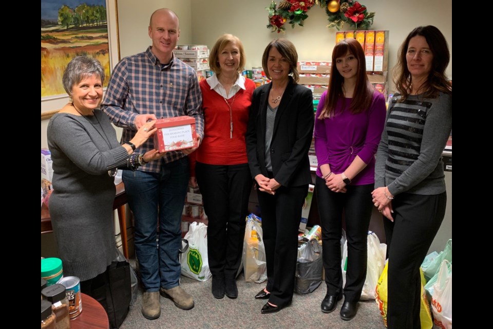 IPC Investment Corporation Orillia presented food and cash donations recently to The Sharing Place Food Centre. Pictured with Sharing Place executive director Chris Peacock are Grace Szalay, Susan Peterson, Donna Racco, Laura Durham and Laurie Murphy. Supplied photo