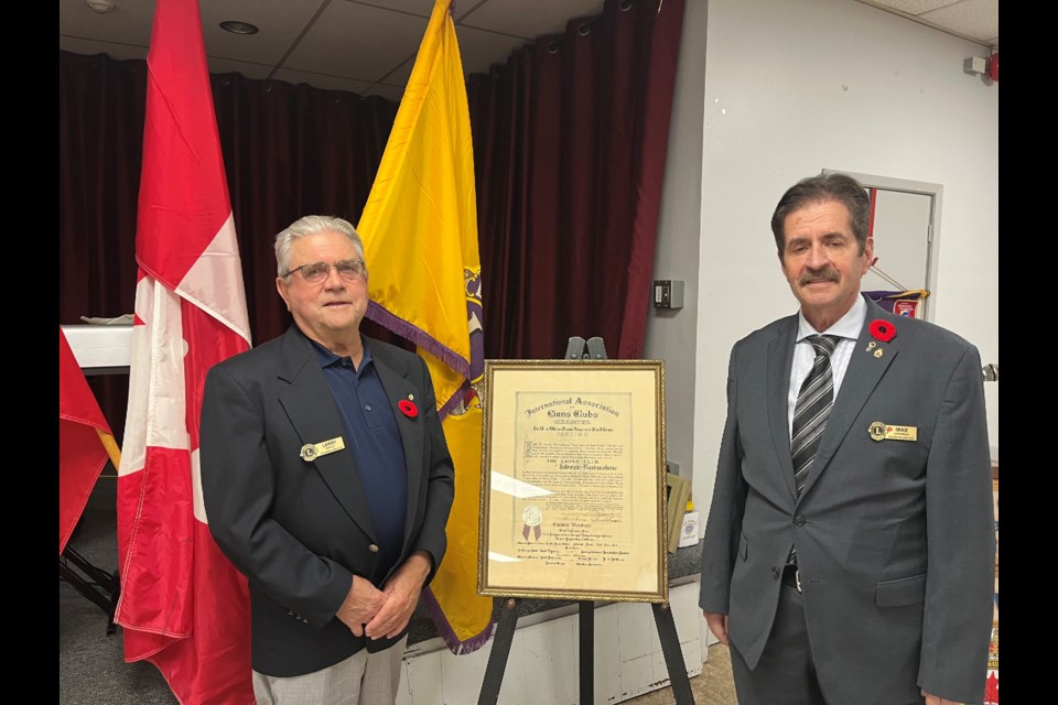 Larry Morley and Mike Larochelle pose next to the Coldwater Lions Club charter from 1939. The busy local club celebrated 85 years of service on Saturday night.