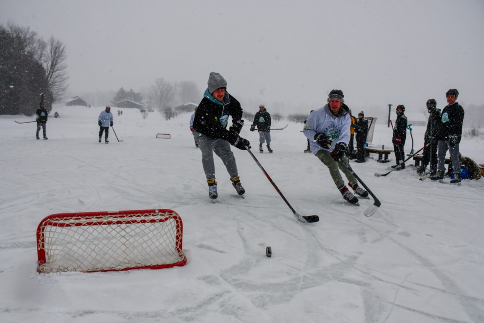 Two players battle for the puck as it rolls by the net at the Braestone Winter Classic on Sunday. The 3-on-3 tournament is hoping to raise $155,000 for the regional cancer centre at RVH.