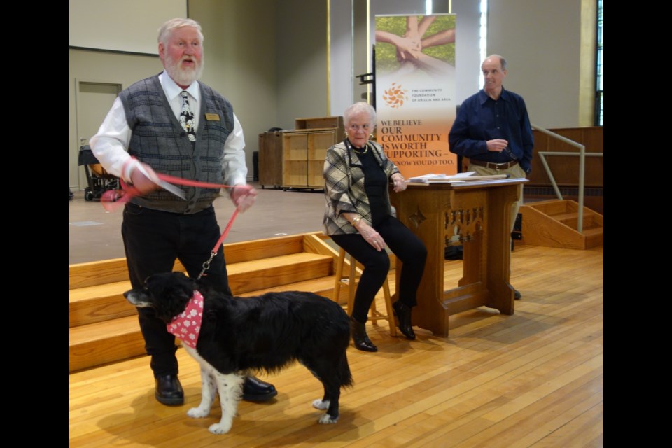 Tom Molloy of the Orillia SPCA brought a dog to the Community Foundation of Orillia and Area's announcement of funding for various local organizations. Contributed photo