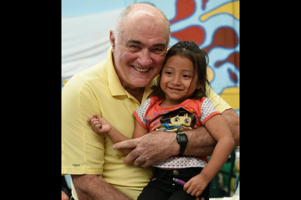 Garry Fell is pictured holding Helen, the daughter of one of Paso Por Paso's university graduates. Gary Fell, a long-time supporter of Orillia-based charity, Paso por Paso, died in December. Supplied Photo