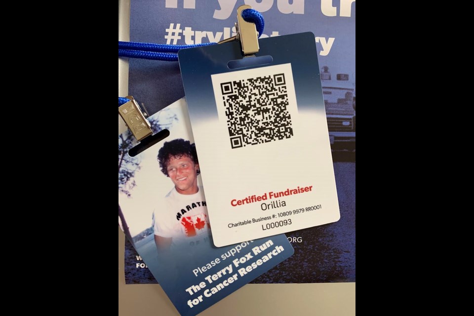 Terry Fox Run volunteers are wearing lanyards around their neck, carrying a QR code where people can register or donate to the Terry Fox Run and be given a receipt right away.