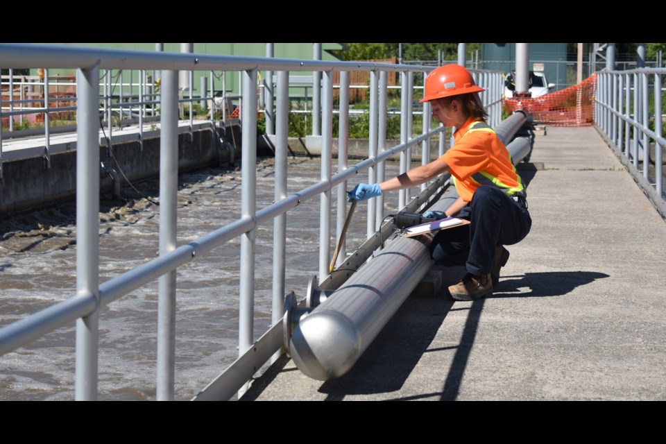 A City of Orillia employee measures how much oxygen is in the wastewater in one of six cells where micro-organisms treat the liquid part of wastewater. Dave Dawson/OrilliaMatters File Photo