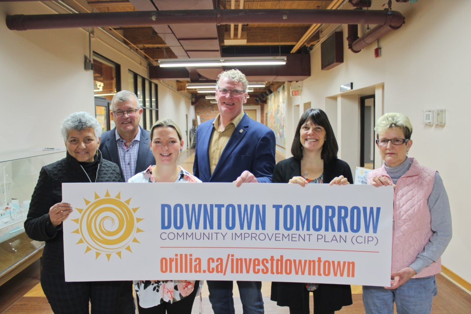 A total of $77,500 in grants from the Downtown Tomorrow Community Improvement Plan was awarded Monday at city hall. On hand were, from left, Laurice Yousof, who is with a company that has purchased the former Orillia Laser Tag building, Jack Steenhof, president of Steenhof Building Services, Raquel Ness, of Hartley Haus, Mayor Steve Clarke, Anna Proctor, communications co-ordinator with St. Paul's Centre, and Diane Cleaveley, owner of Diane's Beauty Salon. Nathan Taylor/OrilliaMatters