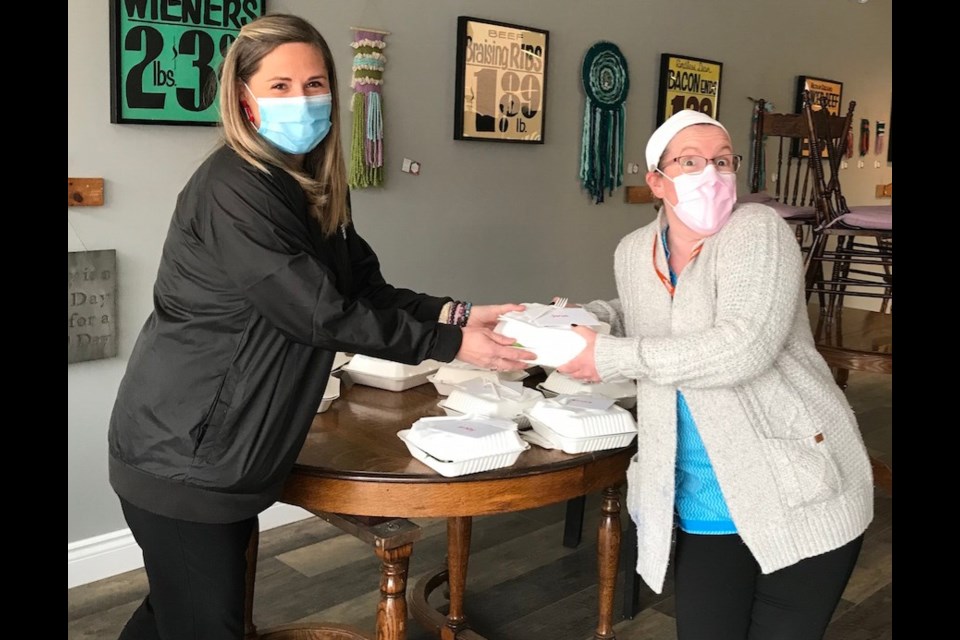 Melissa Knapp from the Old Muskoka Road Beer Store hands travelling nurse Sarah Mennen a free lunch to show appreciation for caring for patients during a scary time. Contributed photo