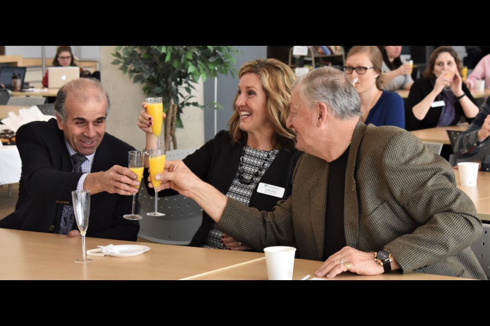 Severn Township Mayor Mike Burkett, left, Lakehead University’s Shelly Unwin and others toasted the $1 million donation to Lakehead from the County of Simcoe. Dave Dawson/OrilliaMatters