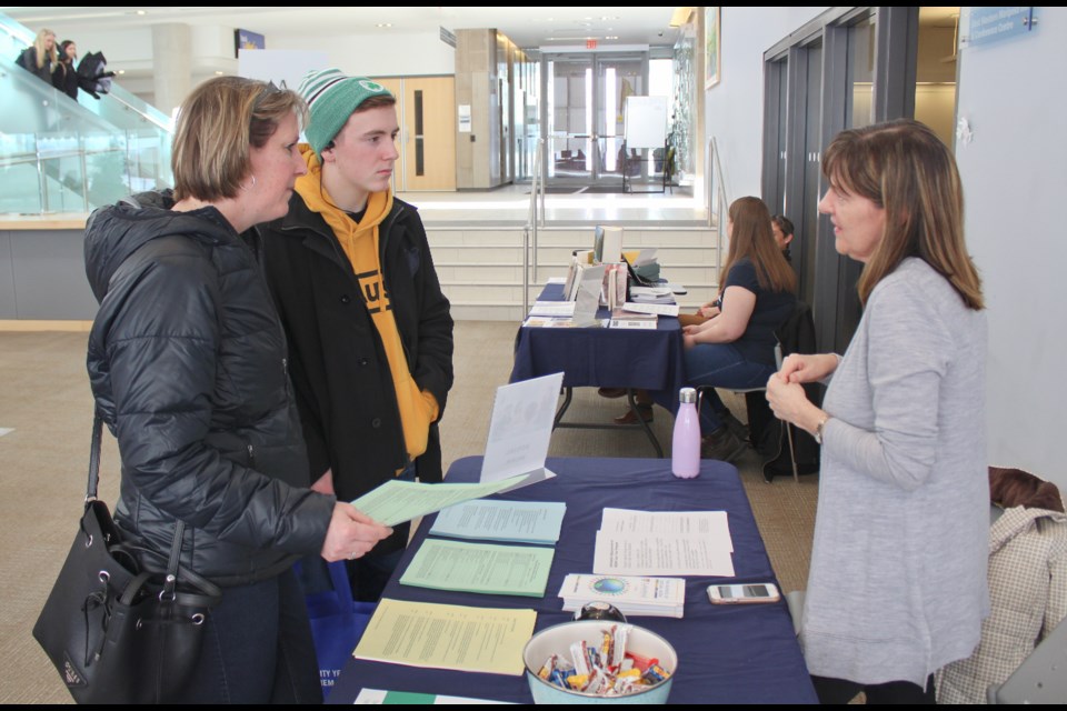 Cameron Turner and his mother, Cindy Turner, attended an open house Tuesday, March 12, 2019, at Lakehead University in Orillia and spoke with Elizabeth Brownlee of the School of Social Work. Nathan Taylor/OrilliaMatters