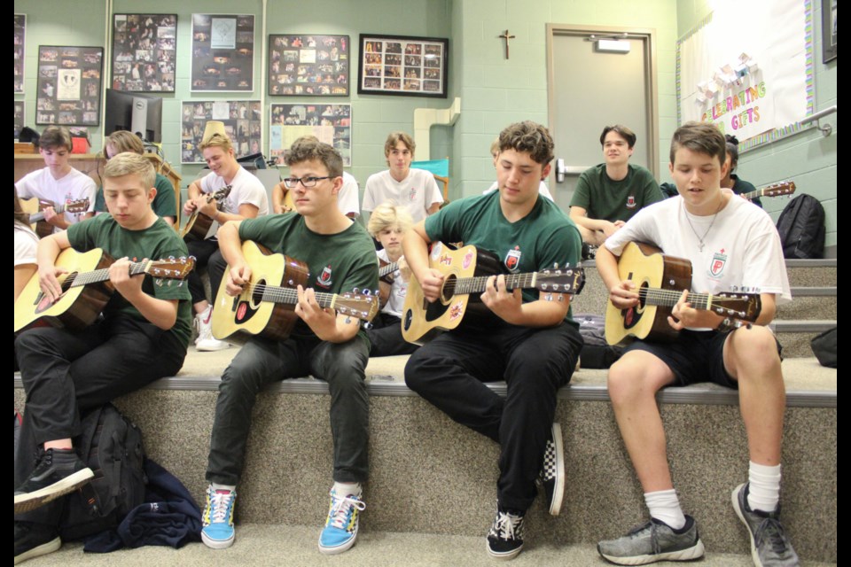 Patrick Fogarty Catholic Secondary School students wasted no time trying out the new guitars that were gifted to the school Wednesday. Nathan Taylor/OrilliaMatters