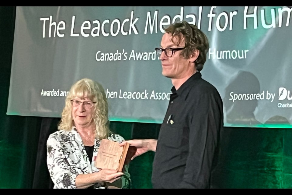 Daphne Mainprize, president of the board of directors for the Stephen Leacock Associates, presents Patrick deWitt with the coveted Stephen Leacock Medal for Humour at Saturday night's gala dinner.