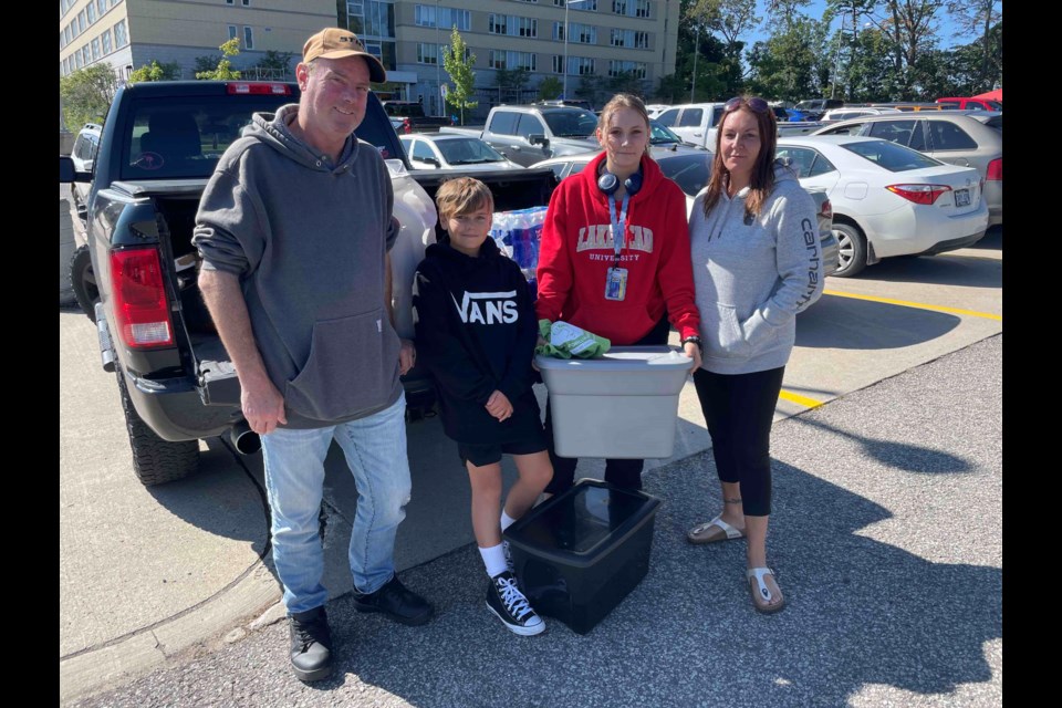 Savanah Denomme, second from right, a first-year Lakehead University education student, had help from her family Thursday morning as she moved into campus residence. She is shown with Jason Japp, left, Zachary Denomme and Nichole Denomme.