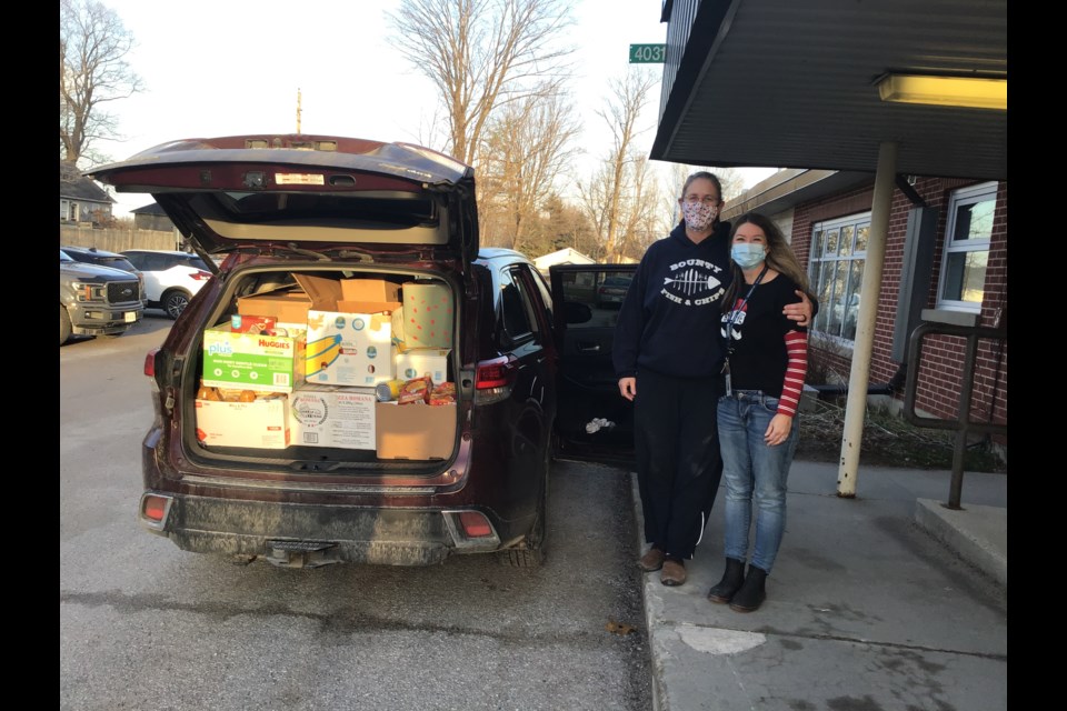 Teresa Love and Lisa Stephens are shown with one of the three loads needed to move about 1,800 collected food items from Warminster Elementary School to the Salvation Army in Orillia.