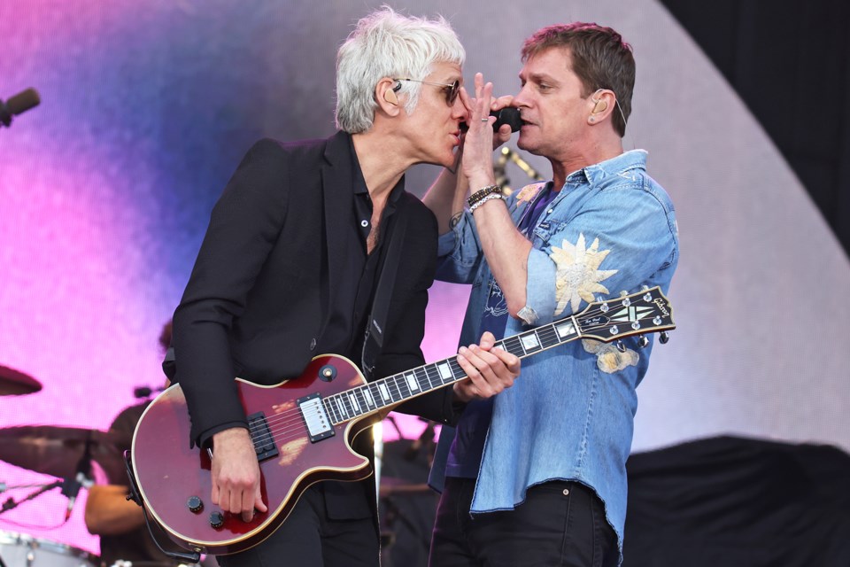 Rob Thomas adjusts Kyle Cook's sunglasses mid-song as Matchbox 20 performs at Boots and Hearts at Burl's Creek Event Grounds in Oro-Medonte on Saturday night.