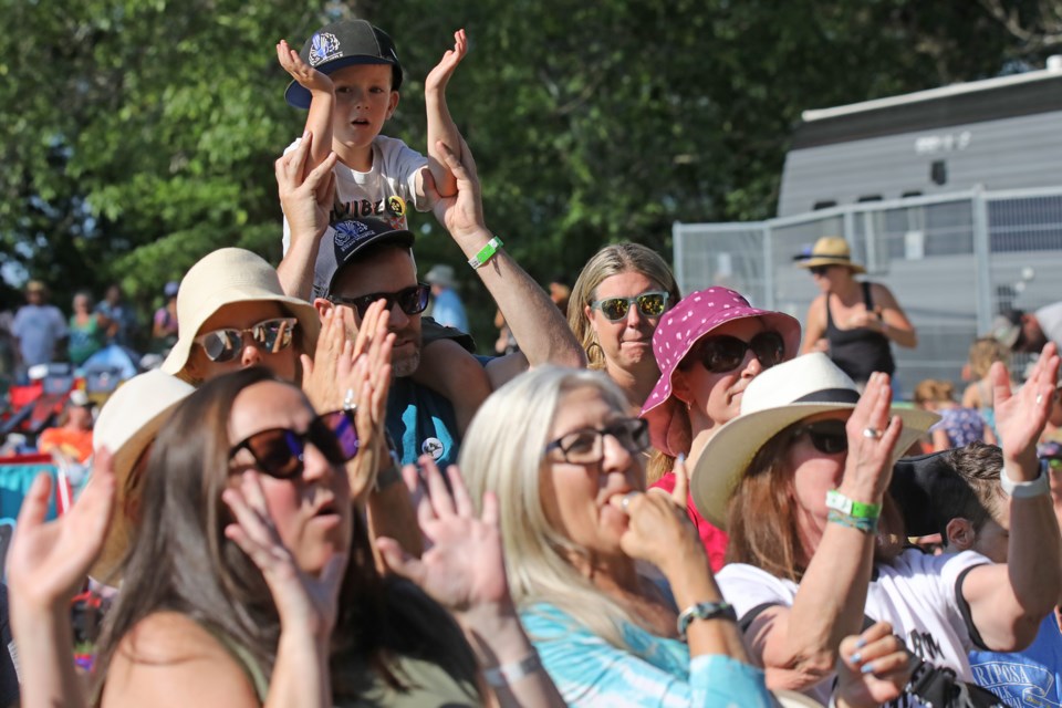 Concert-goers young and old cheer on the performers on the main stage at the Mariposa Folk Festival on Saturday.