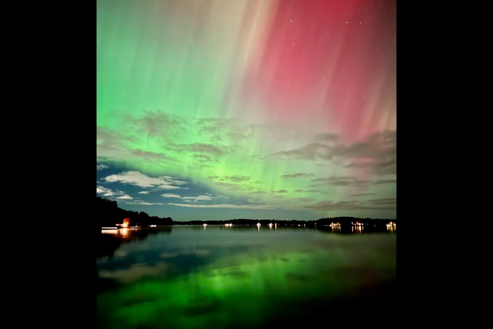 The northern lights are reflected on the lake in Oro-Medonte.