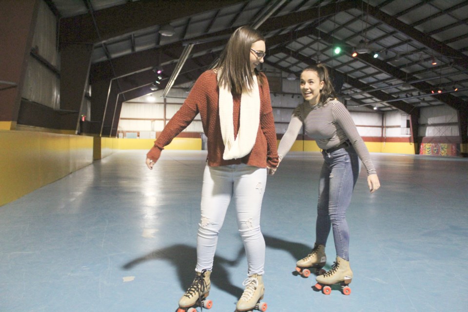 They had a rocky start, but Lakehead Orillia students Lauren Oke, left, and Kresson Taylor found their feet Wednesday at The Roller Skating Place during the university's annual Festivus celebration. Nathan Taylor/OrilliaMatters