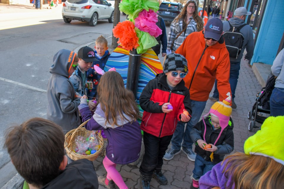 Kids collect plastic eggs to be exchanged for chocolate during the Downtown Orillia Easter Egg Hunt on Saturday.