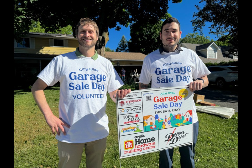 Orillia City Councillors Jay Fallis, left, and Jeff Czetwerzuk helped to organize the city-wide Garage Sale Day on Saturday morning. Proceeds will go to the city's affordable housing reserve fund to help ensure more affordable housing is built within Orillia.