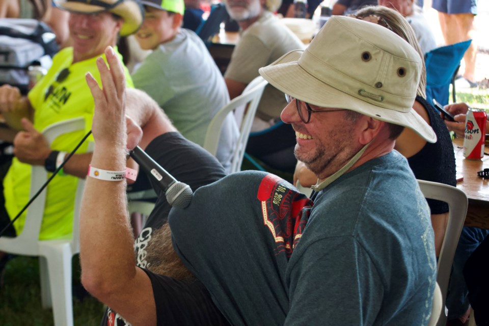 BA Johnston gets up close with a patron of the Mariposa Folk Festival pub tent during the I Love This Town Workshop, Saturday, July 6, 2024 at Tudhope Park in Orillia.