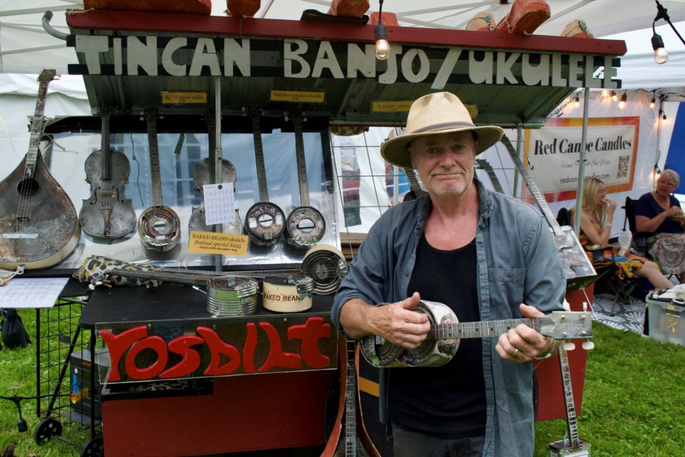 Ross Stewart of RosBilt shows off one of his metal ukuleles during the first day of the Mariposa Folk Festival, Friday, July 5, 2024, at Tudhope Park in Orillia.
