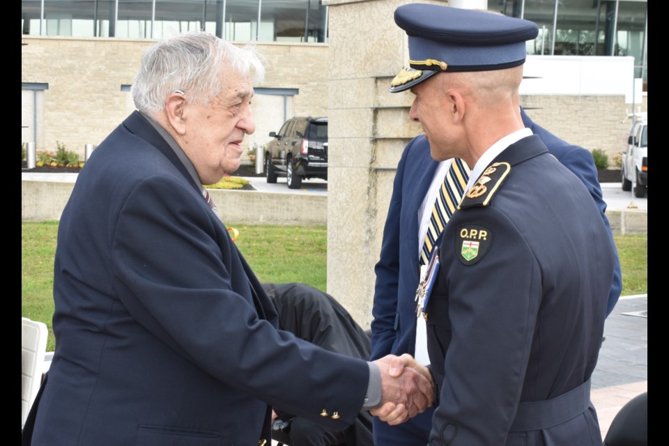 Retired Orillia Police officer Neil Hurtubise, who was shot in the line of duty, meets OPP Commissioner Thomas Carrique at a ceremony at OPP Headquarters. Dave Dawson/OrilliaMatters File Photo