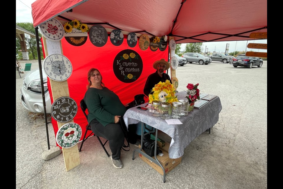 Rosemarie and Kelvin Edmar, along with their dog King, sell crafted creations at the Orillia Flea Market. 