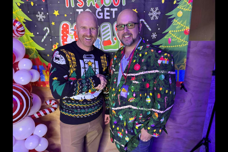 Chris Peacock, left, executive director of The Sharing Place, is shown with Ugly Sweater Bowling Party Organizer Derick Lehmann at Friday night's sold-out event that raised more than $4,000 for the local food bank.