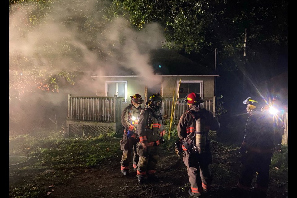 Orillia firefighters battle a blaze at a boarded-up home on Clifford Street in the Orchard Point area.