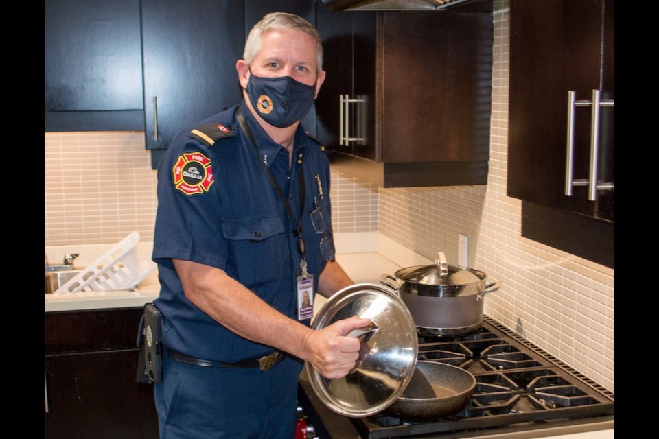 Orillia Fire Department Fire Prevention Officer, David Baker, demonstrates safe cooking in the kitchen during Fire Prevention Week. Tyler Evans/OrilliaMatters.