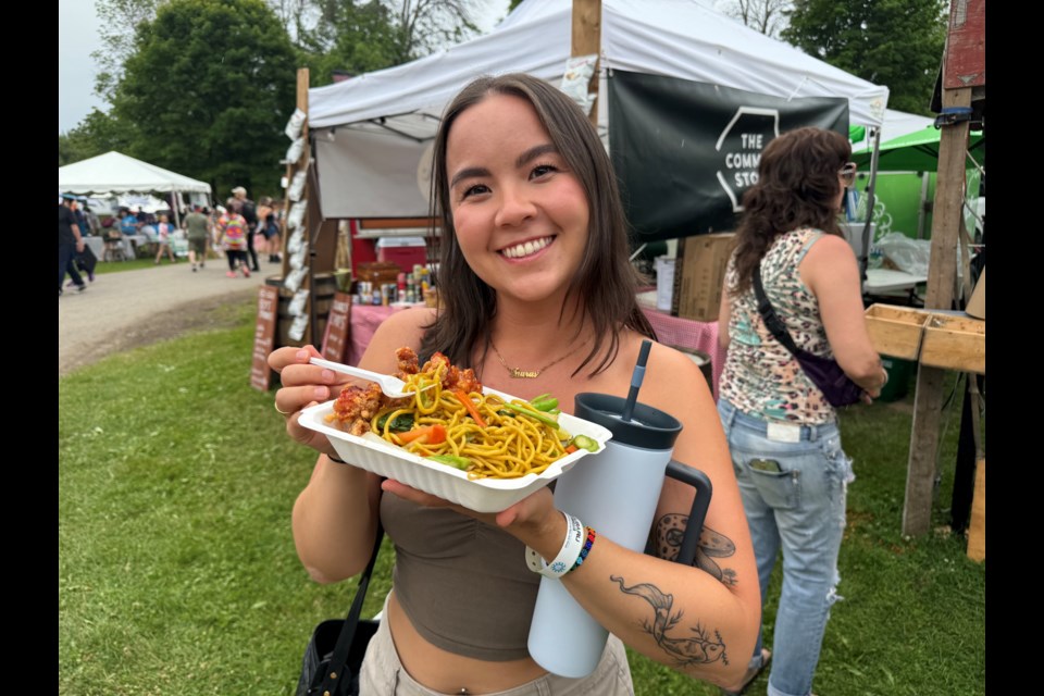 Amy Tanaka enjoyed chicken yakisoba from Tokyo Angels at the Mariposa Folk Festival on Friday.