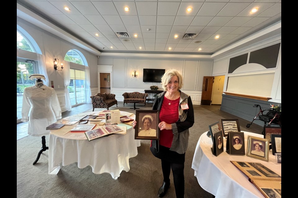 Glenna Tinney, president of the Orillia Soldiers' Memorial Hospital Nurses Alumnae and graduate of the class of 1972, holds a photo of her friend, who also graduated from the local nursing school.