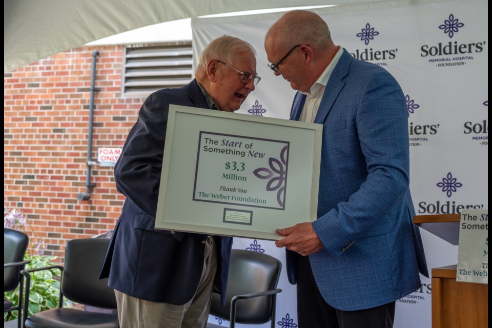 Weber Foundation founder Reinhart Weber shares an emotional moment with Orillia Soldiers' Memorial Hospital Foundation president and CEO Perry Esler after donating $3.3 million to the hospital foundation.