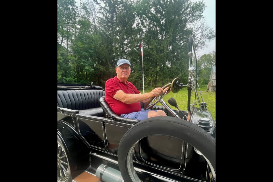 Guest speaker John Smith is shown at the wheel of his 1913 McLaughlin.