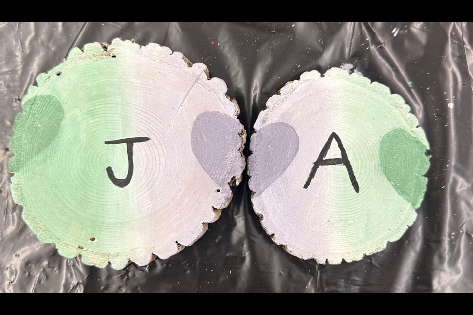 At a recent monthly event for Big Brothers Big Sisters of Orillia and District, matches Josie and Andy painted each other's initials in their favourite colours of purple and green, respectively.