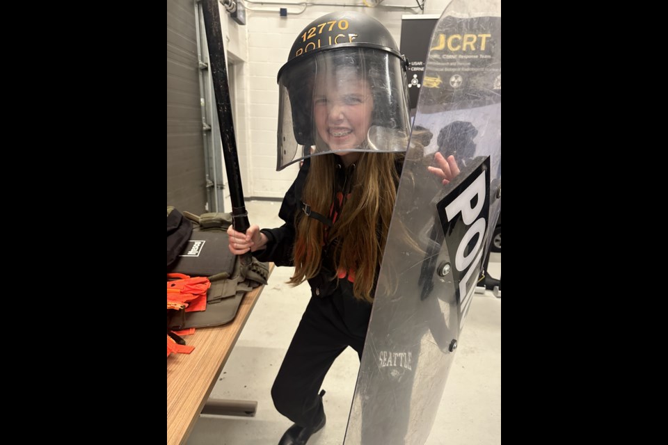 Little Sister Andy and Big Sister Josie Gullusci visited the Orillia OPP detachment, where Andy got to try on riot gear.