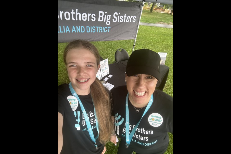 Little Sister Andy, left, and Big Sister Josie Gullusci volunteered at the Big Brothers Big Sisters Orillia and District booth at the Christmas in June festival and signed up a few prospective mentors.