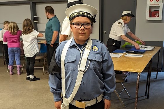 Navy League Cadet Corps (NLCC) Orillia No. 199 member Hunter Tripp is instructed on his role as flag bearer during the meeting Monday night at ODAS Park.