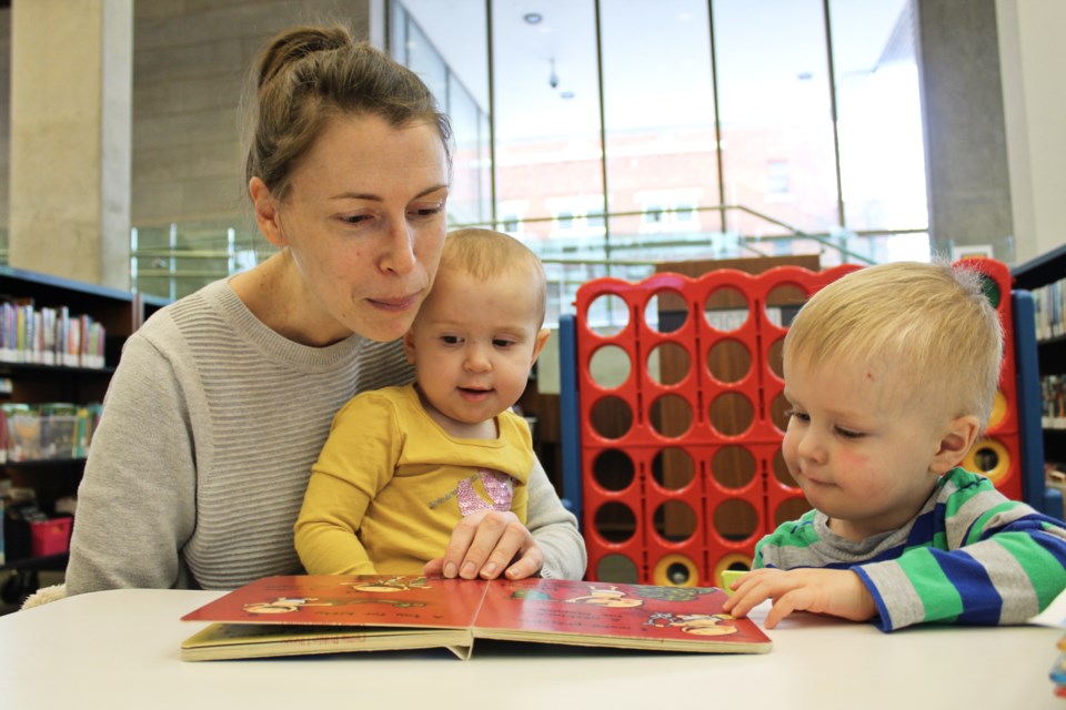 Erin Cloutier reads with her daughter, Natalie, and son, Connor, at the Orillia Public Library. Nathan Taylor/OrilliaMatters