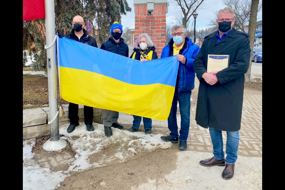 The Ukrainian flag was raised Thursday in front of the Orillia Opera House. From left are councillors David Campbell, Tim Lauer, Pat Hehn and Ralph Cipolla, and Mayor Steve Clarke.