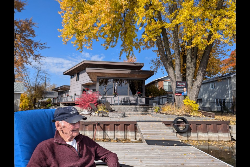 Eric Carman relaxes on the dock at his Cedar Island Road home, which is being featured on the A&E show Lakefront Luxury.