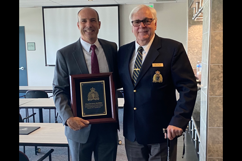 RCMP Insp. Tim Dell'Anna, left, Toronto North detachment commander, and Gerry McMillan are shown on Aug. 20 during an event in recognition of McMillan's 27 years as chaplain for the police force.