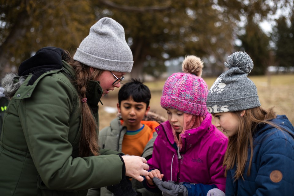 Students and the Nottawasaga Valley Conservation Authority’s environmental educator investigate nature.